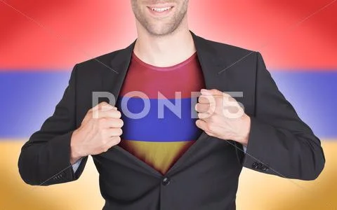 Businessman opening suit to reveal shirt with armenia flag Stock Photos