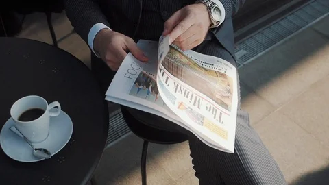 The businessman opens the newspaper for reading. Stock Footage 121401149