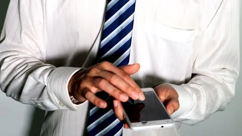 Businessman operating a smartphone Video stock 334677562