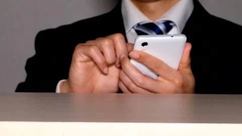 Businessman operating a smartphone Stock Footage 334839626