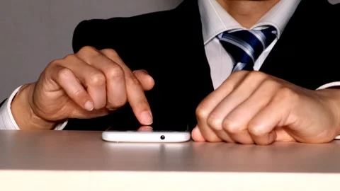 Businessman operating a smartphone Video stock 334840808