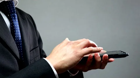 Businessman operating a smartphone Stock Footage 336419290