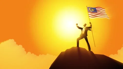 Businessman optimistically standing on a mountain holding the flag of Malaysia Stock Footage 276303203