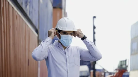 Businessman or engineer wearing hard hat and wearing face mask to prevent COVID Stock Footage 159277003