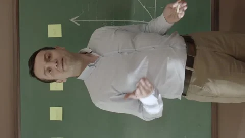 A businessman or teacher is explaining graphics to employees or students. Stock Footage 204145964