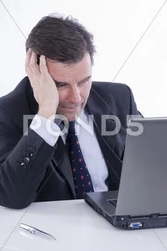 Businessman, over 50, working on a laptop Stock Photos