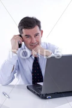 Businessman, over 50, working on a laptop Stock Photos