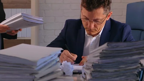 A businessman is overloaded by work with data. 스톡 동영상 129523845