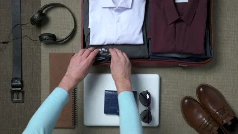 Businessman packing a suitcase Stock Footage 141847679