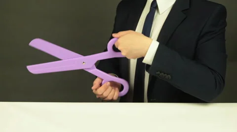 A Businessman with a Pair of Scissors Stock Footage 62349088