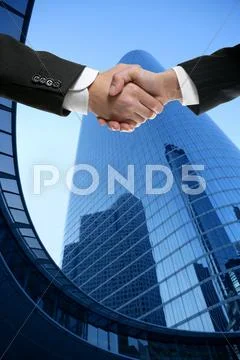 Businessman partners shaking hands with suit Stock Photos