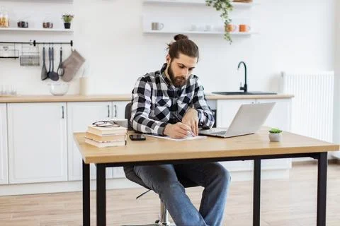 Businessman with pen making notes on draft of paper document. Stock Photos