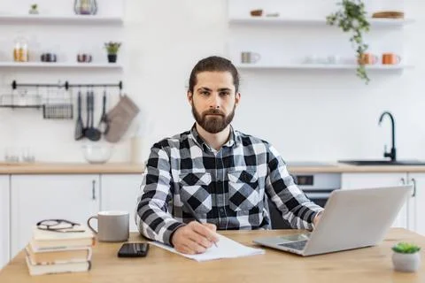 Businessman with pen making notes on draft of paper document. Stock Photos