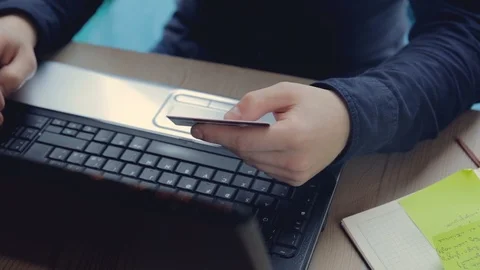 A businessman performs an online payment in a cafe on a laptop computer 動画素材 91380922