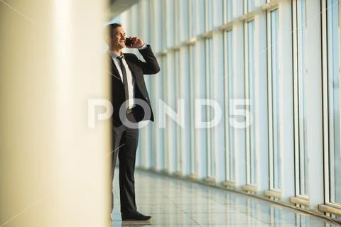 The businessman phone in the business center hall Stock Photos