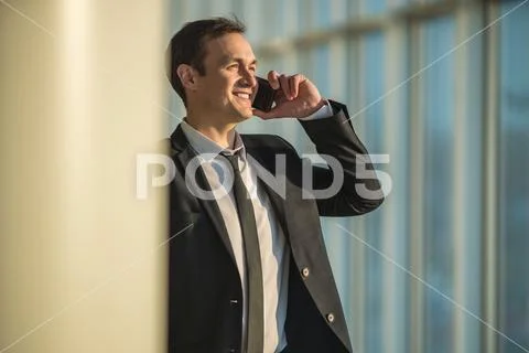 The businessman phone near the column Stock Photos