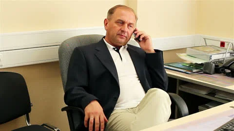 Businessman pick up the phone in front of the computer table. Stock Footage 24868708