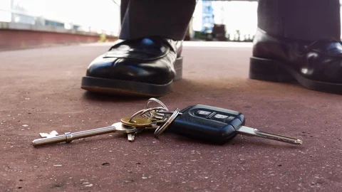 Businessman picking up lost keys Stock Footage 104069678