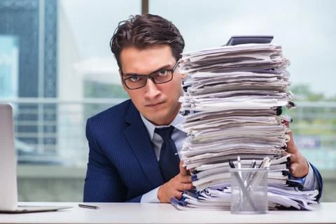 Businessman with pile stack of paper paperwork in the office Foto stock
