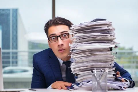 Businessman with pile stack of paper paperwork in the office Foto stock