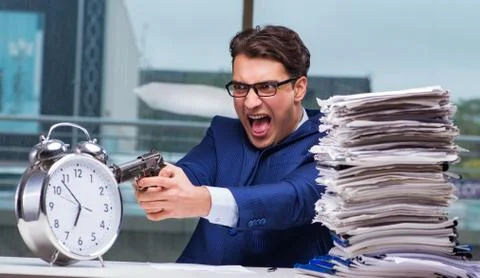 Businessman with pile stack of paper paperwork and an alarm cloc Foto stock