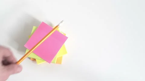Businessman Placing a Pencil on a Stack of Sticker Notes Stock Footage 154659184
