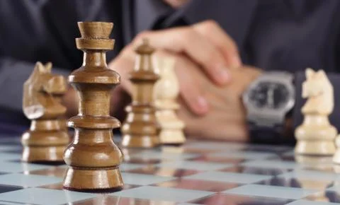 Businessman playing chess Stock Photos