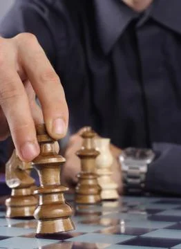 Businessman playing chess Stock Photos