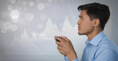 Businessman playing with computer game controller with bright charts background Stock Photos