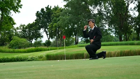 Businessman playing Golf ball practice hit swing on tee in golf club Видео 265050803