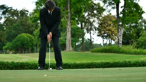 Businessman playing Golf ball practice hit swing on tee in golf club Видео 265050816