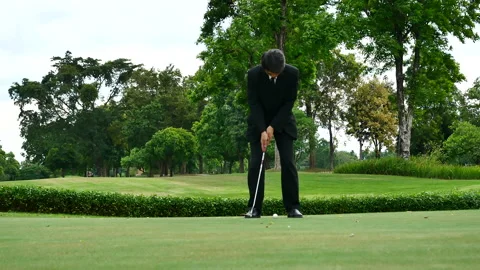 Businessman playing Golf ball practice hit swing on tee in golf club Видео 265050817