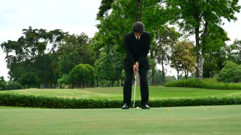 Businessman playing Golf ball practice hit swing on tee in golf club Видео 265050818