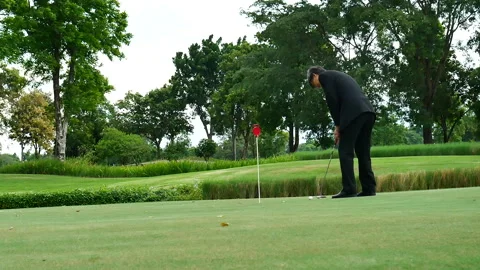 Businessman playing Golf ball practice hit swing on tee in golf club Stock Footage 273460847