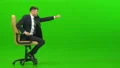 The businessman playing on the office chair on the green background 4k or 4k+ Resolution