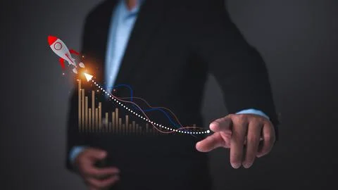 Businessman pointing at data graph with a rocket icon symbolizing rapid sta.. Stock Photos