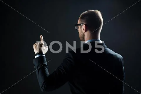 Businessman pointing finger to something invisible Stock Photos