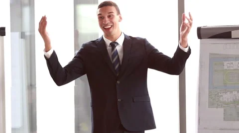 Businessman pointing at flipchart during presentation Stock Footage 59541942