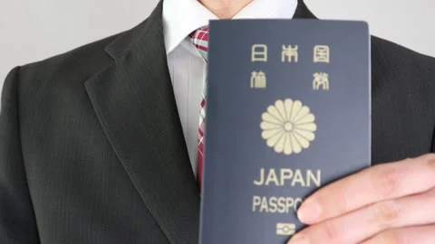 Businessman pointing at a passport valid for five years Stock Footage 325693470