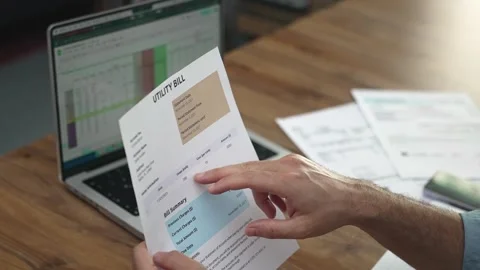 Businessman points finger at text sentence while reading and entering data into Stock Footage 282817608