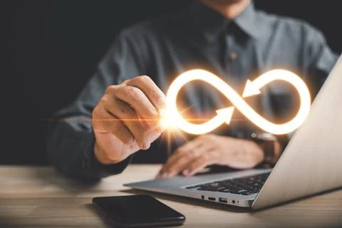 Businessman points to infinity symbol, representing limitless connection in data Stock Photos