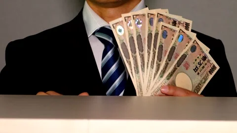 A businessman poses while fanning himself with banknotes. Stock Footage 335029668