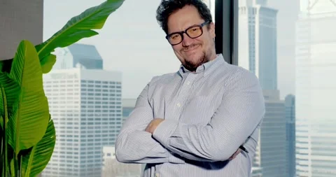 Businessman Posing Confidently in Skyscraper Office Stock Footage 323680133