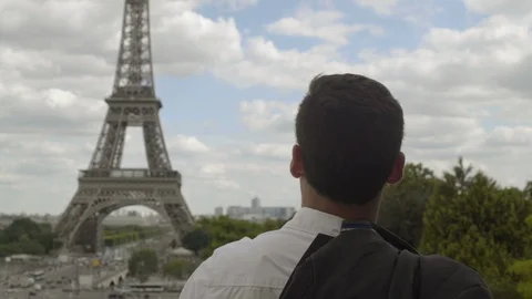 Businessman posing at the Eiffel Tower after work, with a white shirt, a jacket Video stock 111926566