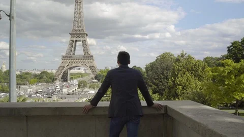 Businessman posing at the Eiffel Tower after work, with a white shirt, a jacket Stock-Footage 111926614