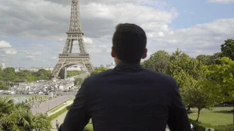 Businessman posing at the Eiffel Tower after work. Handsome Man with brown hair Stock Footage 111926639