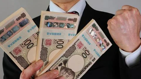 A businessman posing with a stack of banknotes. Stock Photos
