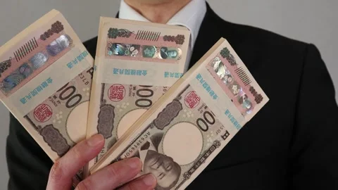 A businessman posing with a wad of bills Stock Footage 325691711
