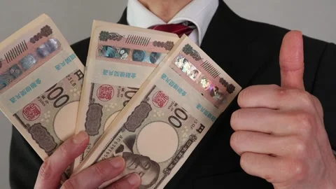 A businessman posing with a wad of bills Stock Footage 325691714