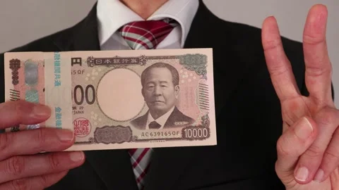 A businessman posing with a wad of bills Stock Footage 325691794